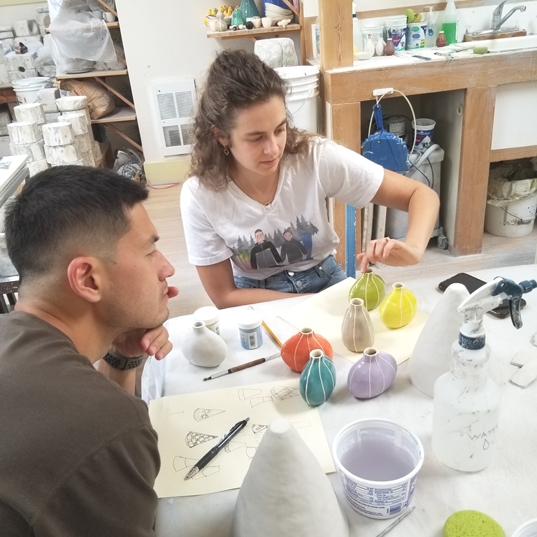 man & woman at ceramic work table